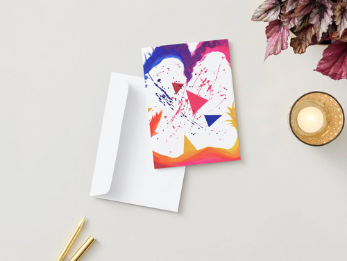 A6 greeting card with abstract colorful triangle artwork, folded, on white card insert