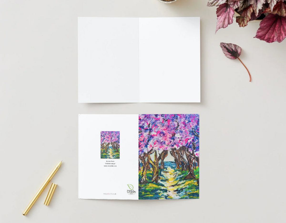 A6 horizontal greeting card featuring a vibrant, hand-painted cherry blossom path design on premium 350gsm satin cardstock.