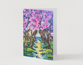 A6 greeting card featuring a vibrant, hand-painted cherry blossom road scene with textured pink, purple, and green brushstrokes.