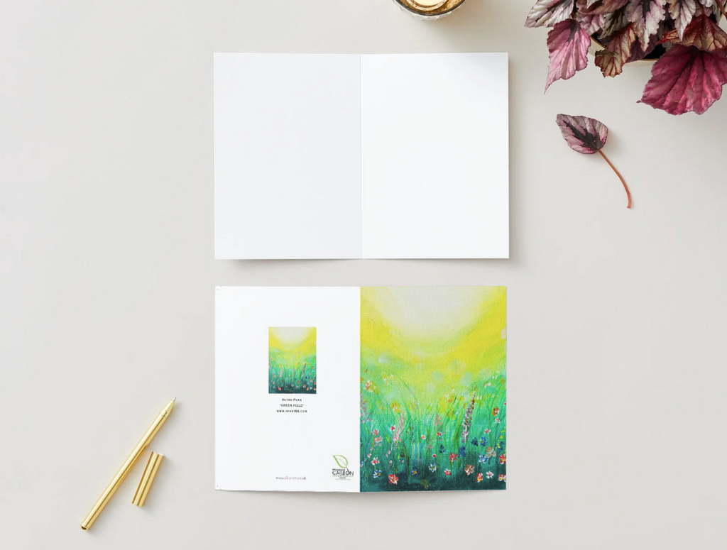 A6 folded greeting card featuring a vibrant hand-painted wildflower meadow design with a satin finish and white interior.