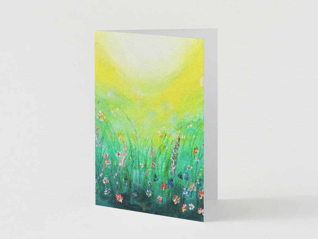 A6 folded greeting card featuring a vibrant hand-painted wildflower meadow in green and yellow with a satin finish.