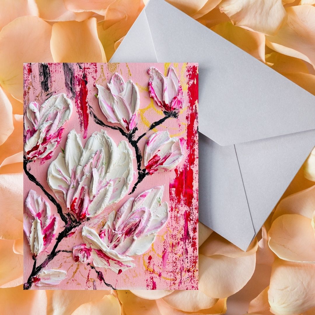 Magnolia greeting card with pink floral artwork and white blossoms on a textured pink background
