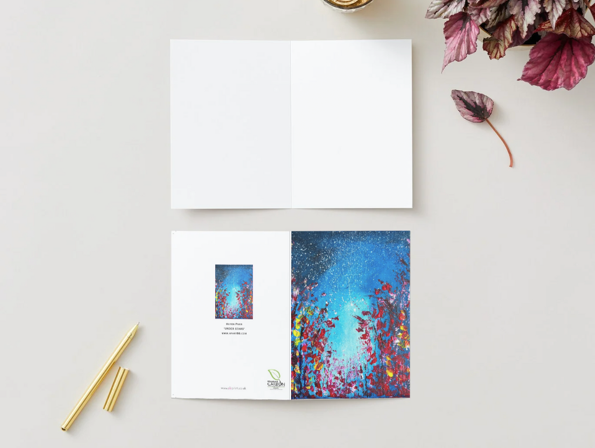 A6 folded greeting card featuring a vibrant, hand-painted starry night landscape with red and blue floral accents.