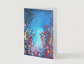 A6 folded greeting card featuring a vibrant hand-painted starlight night sky with red and yellow floral silhouettes.