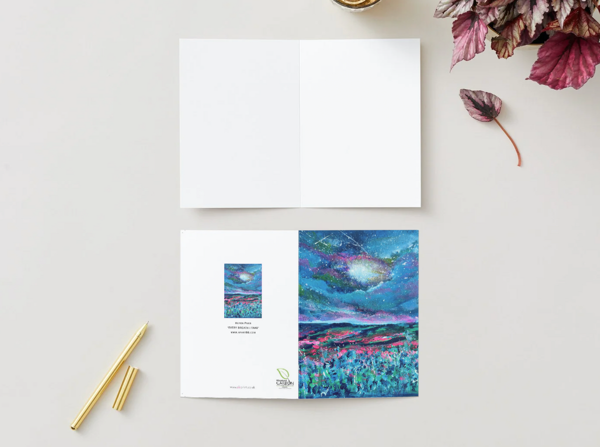 A6 folded greeting card with a hand-painted night sky design in vibrant blue and pink hues on premium satin-finish paper.