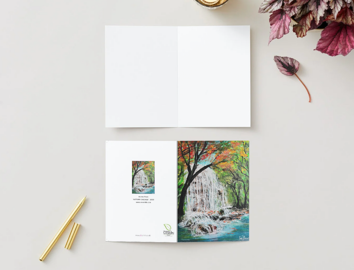 A6 horizontal greeting card featuring a vibrant hand-painted waterfall scene in a forest, printed on premium satin cardstock.
