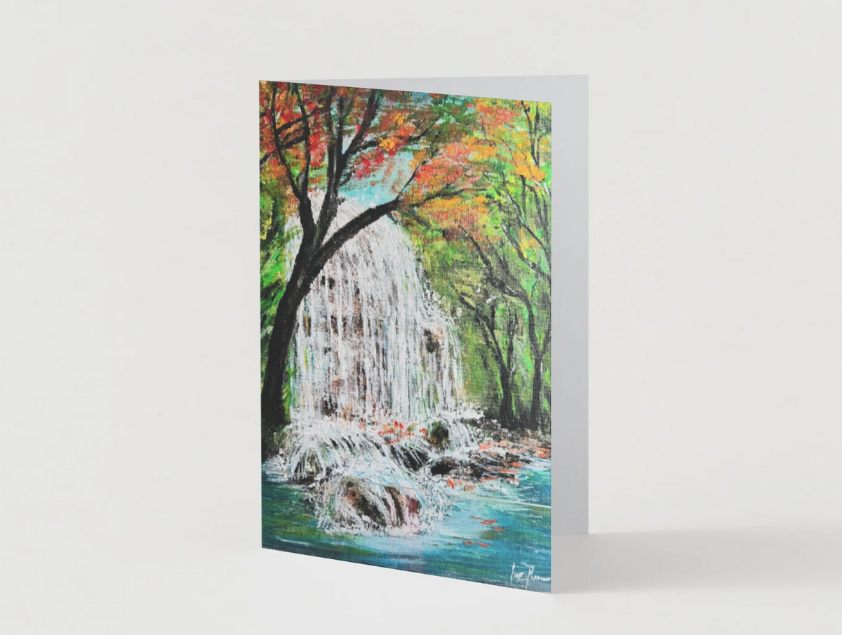 A6 greeting card featuring a hand-painted waterfall in a vibrant autumn forest with a premium satin finish.