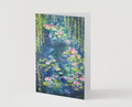 A6 greeting card featuring a hand-painted waterlily pond with vibrant pink flowers and green willow trees in satin finish.