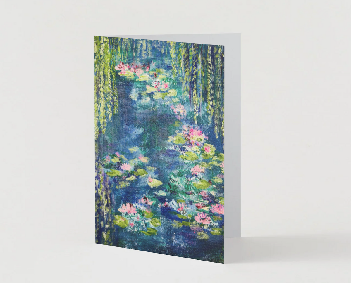 A6 greeting card featuring a hand-painted waterlily pond with vibrant pink flowers and green willow trees in satin finish.