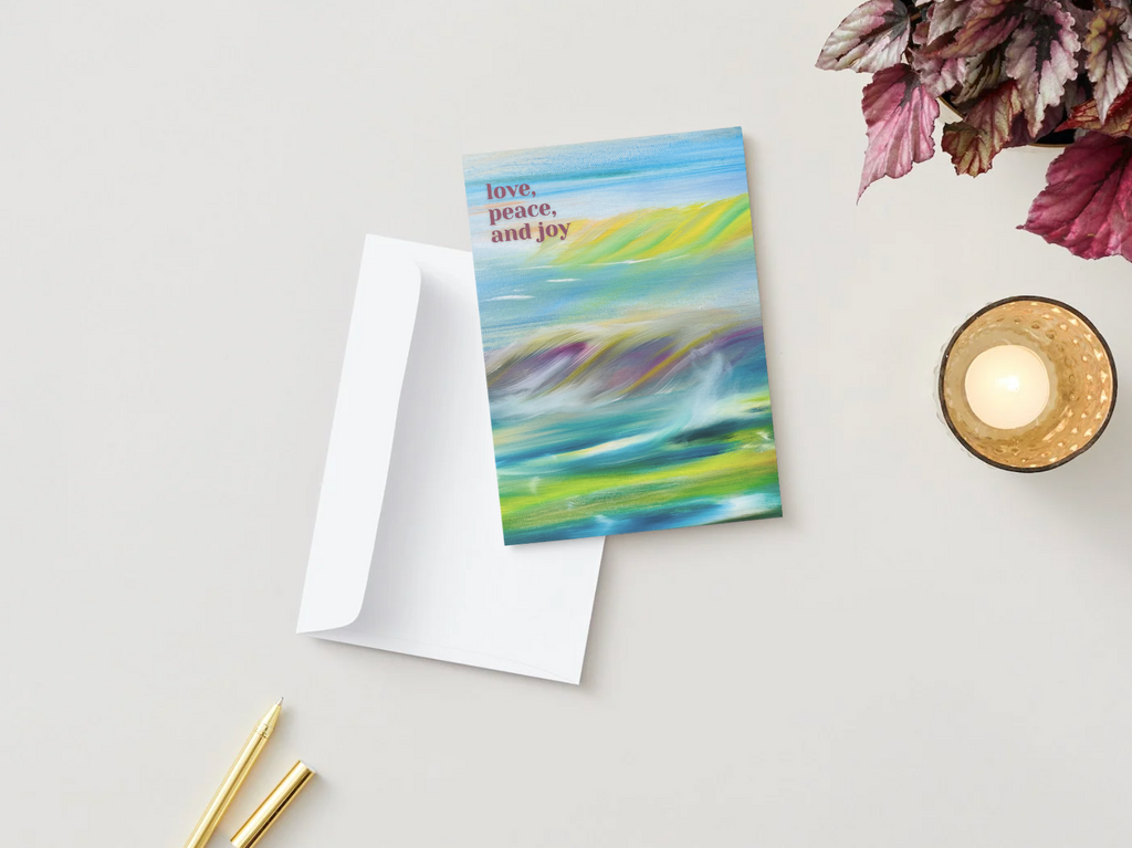 A6 fold greeting card, blue abstract landscape with “love, peace and joy” on cover
