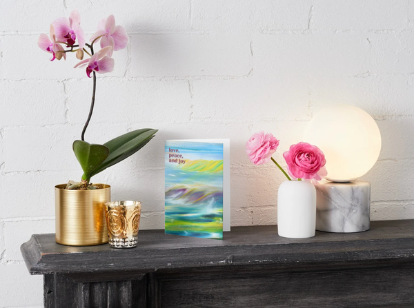 A6 greeting card, blue abstract landscape with “love, peace and joy” on cover