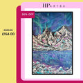Framed abstract landscape print showing gray mountains with teal and magenta reflection