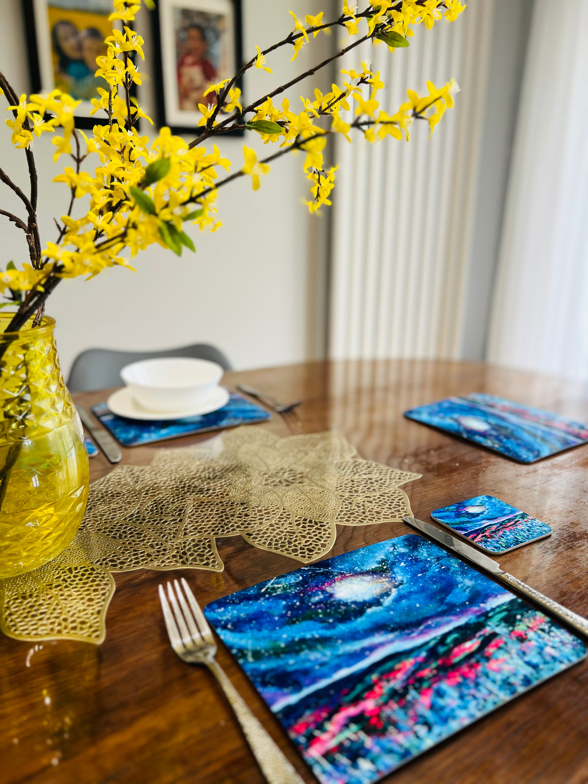 Set of four 23x19cm glossy wooden placemats featuring a vibrant blue night sky art print on a wooden dining table.