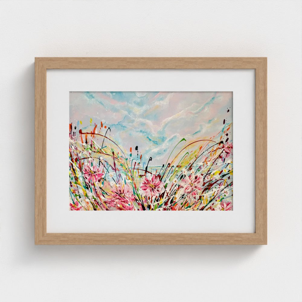 Natural wood framed abstract print with pink flowers, blue sky and colorful splatter