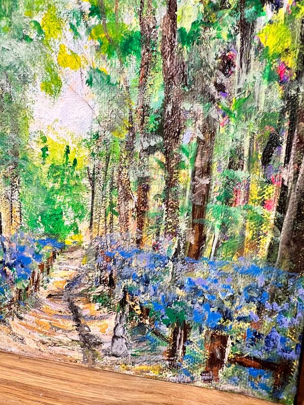 Forest landscape painting showing a winding footpath through tall trees and blue blooms