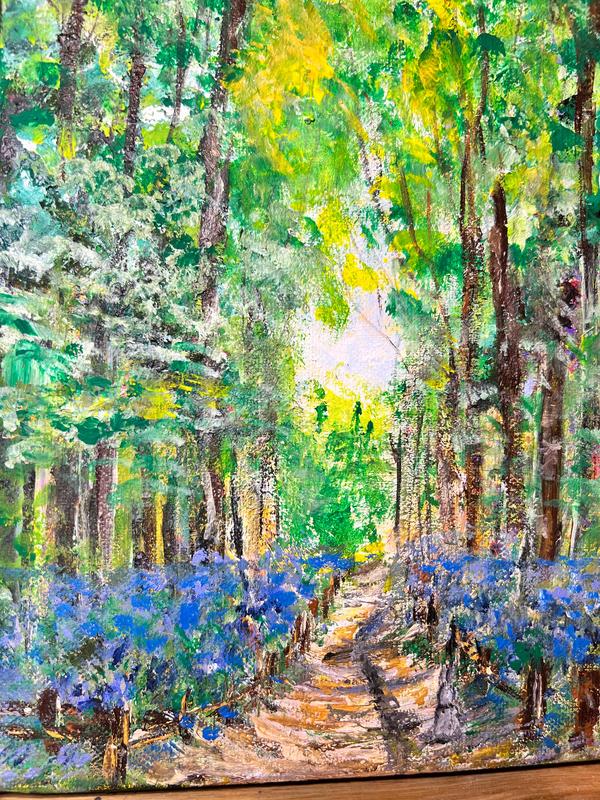 Forest landscape painting with a winding path between tall trees and blue wildflowers