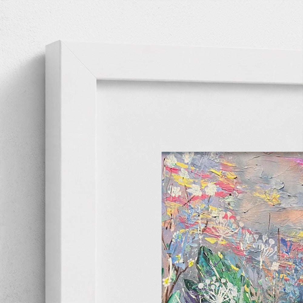 White picture frame corner showing colorful floral art print