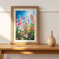 Framed floral art print with pink and orange blossoms and green foliage on blue sky