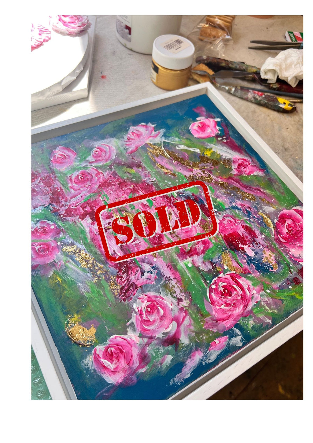 Framed pink roses floral painting on table with red "SOLD" stamp overlay