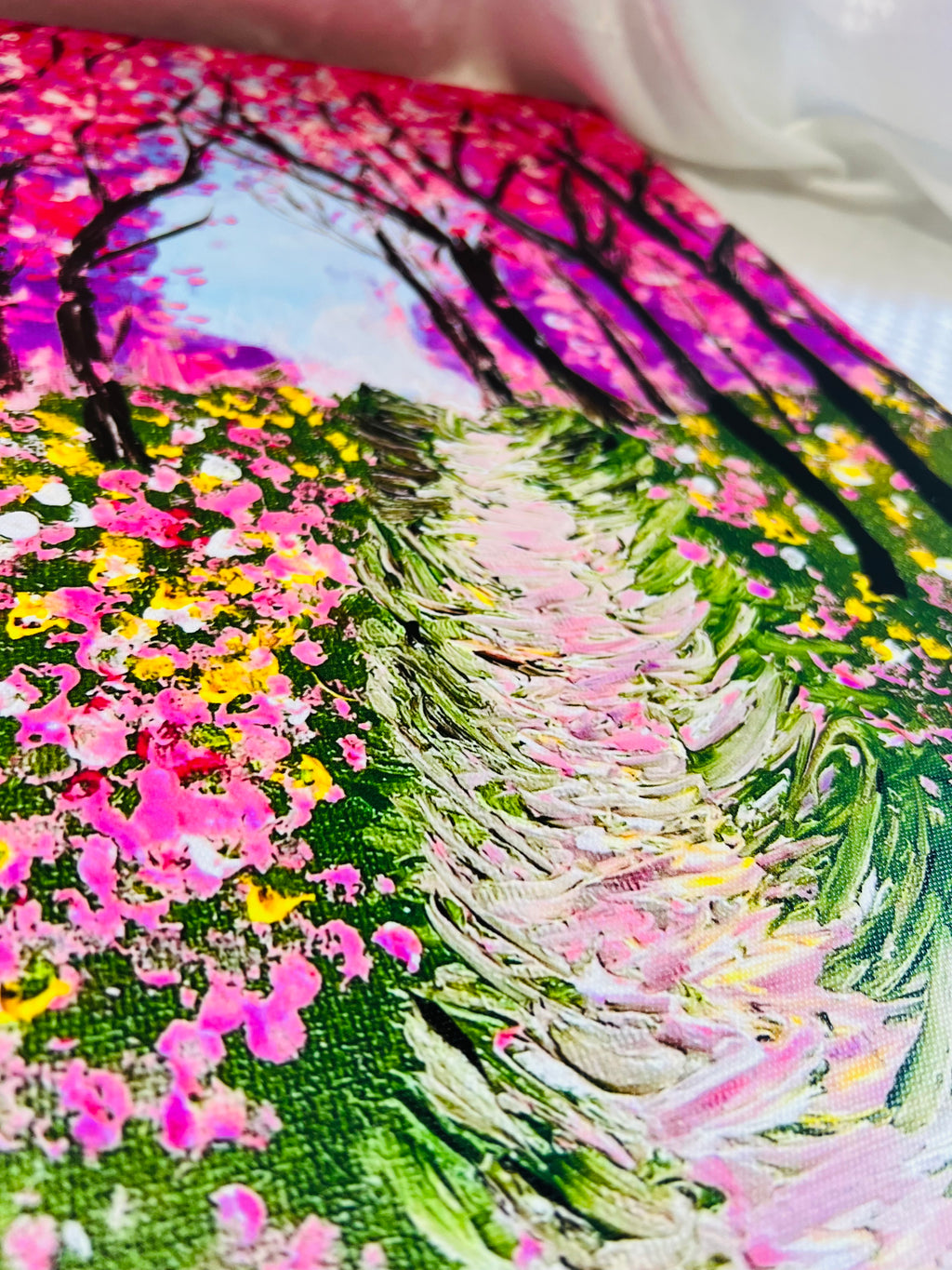 Textured painting of pink cherry blossom trees over a winding path with blooming flowers