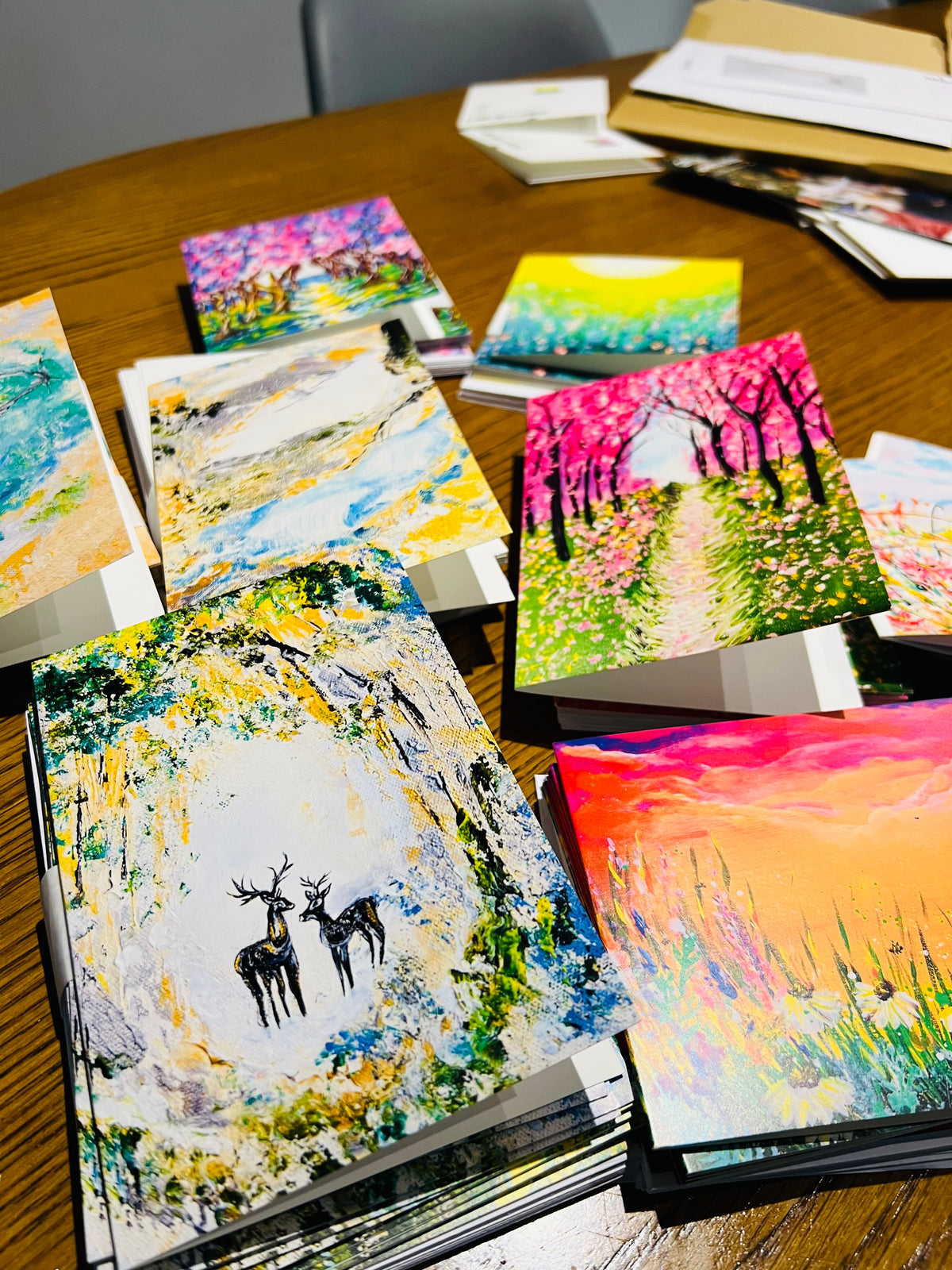 Assorted A6 greeting cards featuring vibrant, textured floral and woodland artwork on premium satin-finish paper.