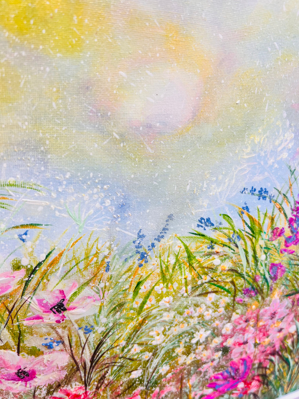 Floral painting with soft sky tones, blue flowers, and yellow-green grasses