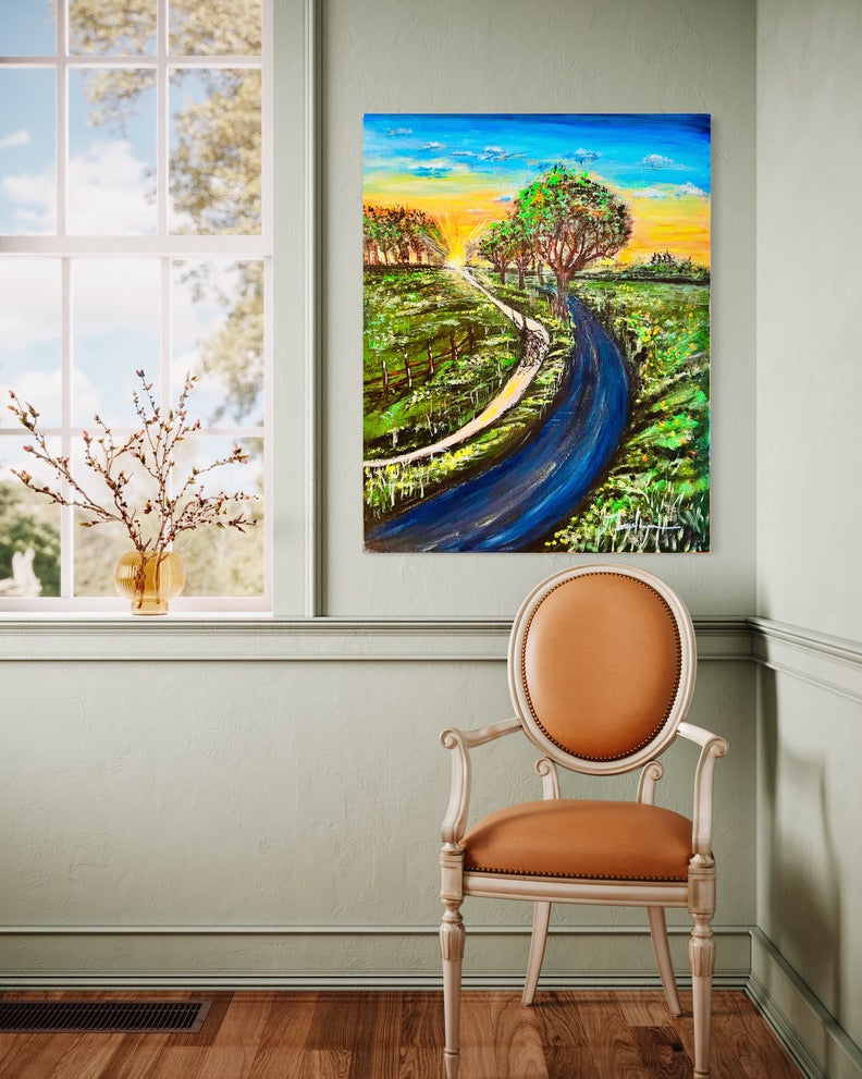 Framed landscape wall art with a winding dark road, trees, and colorful sunset sky.