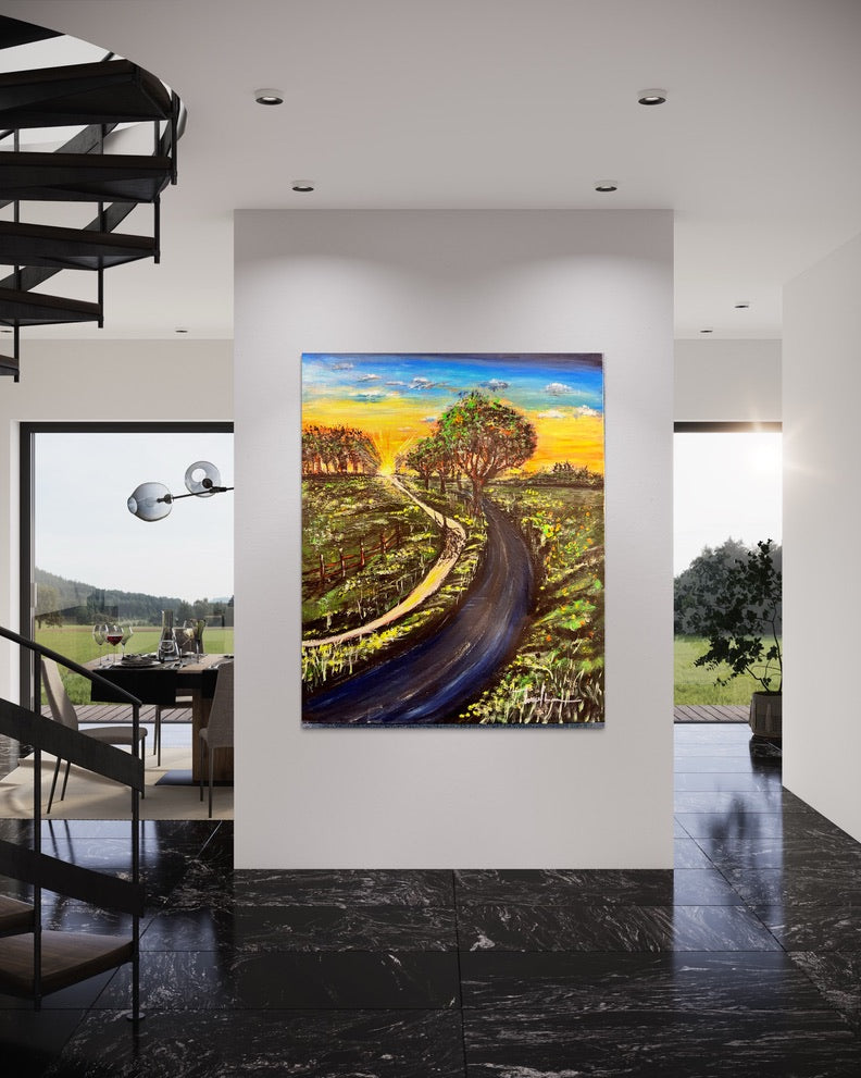 Framed countryside landscape painting with a winding road, trees, and golden-orange sunset.