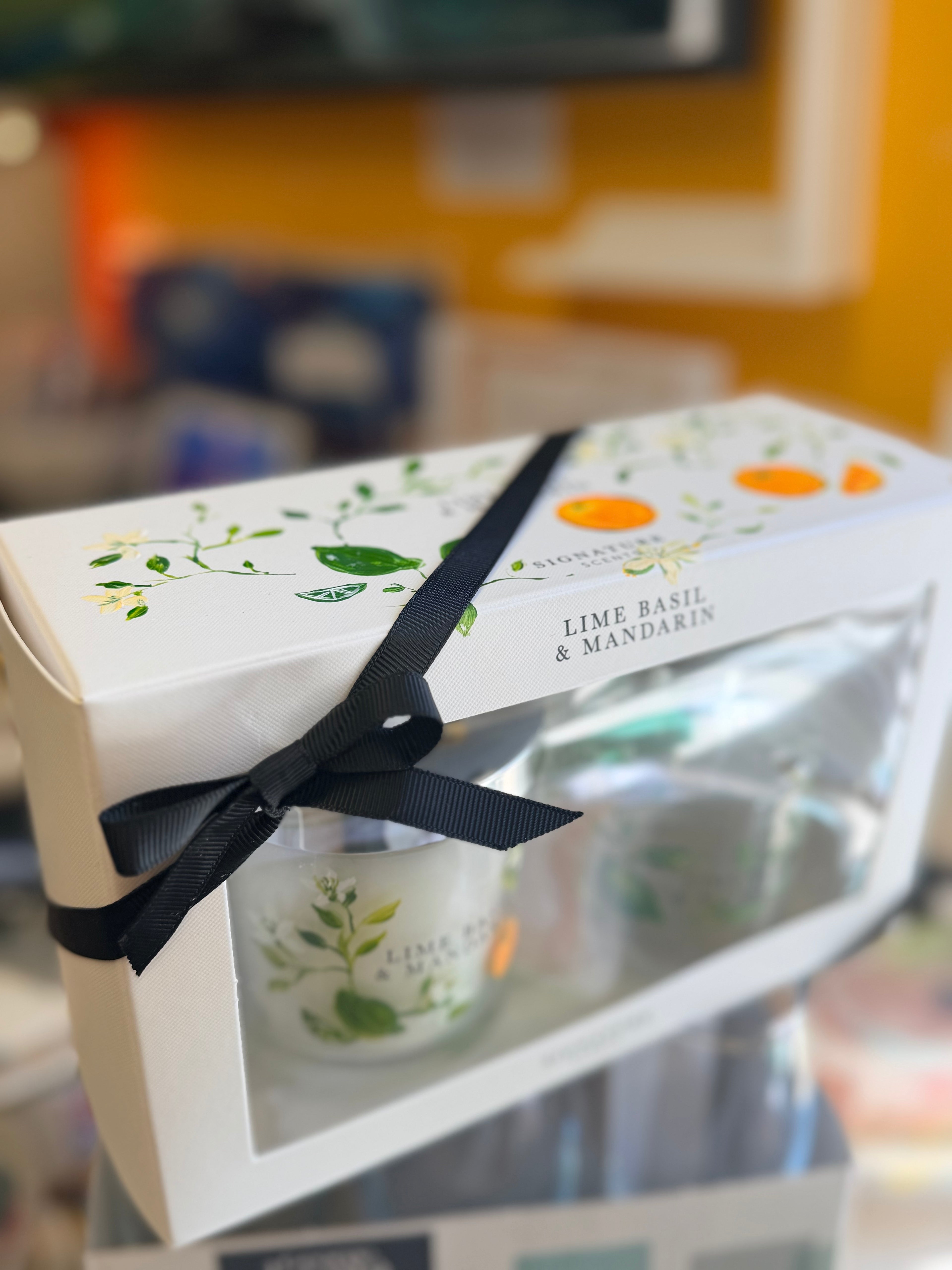 Lime Basil & Mandarin gift set with hand-painted candle and diffuser in a white box tied with a black ribbon.