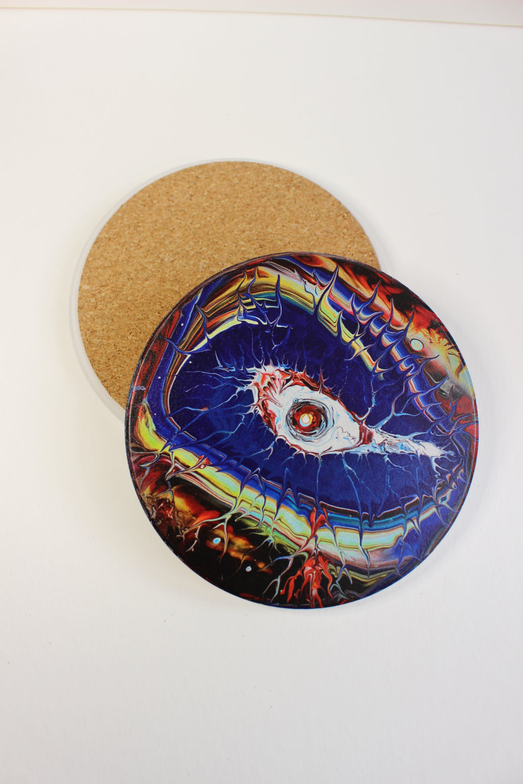 10cm round ceramic coaster with a vibrant, hand-painted eye art print and a protective cork backing.