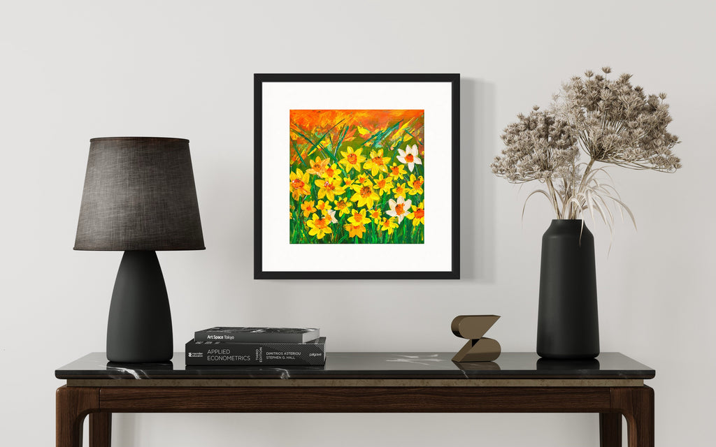 Framed daffodils floral print in black frame with yellow, orange, and white flowers