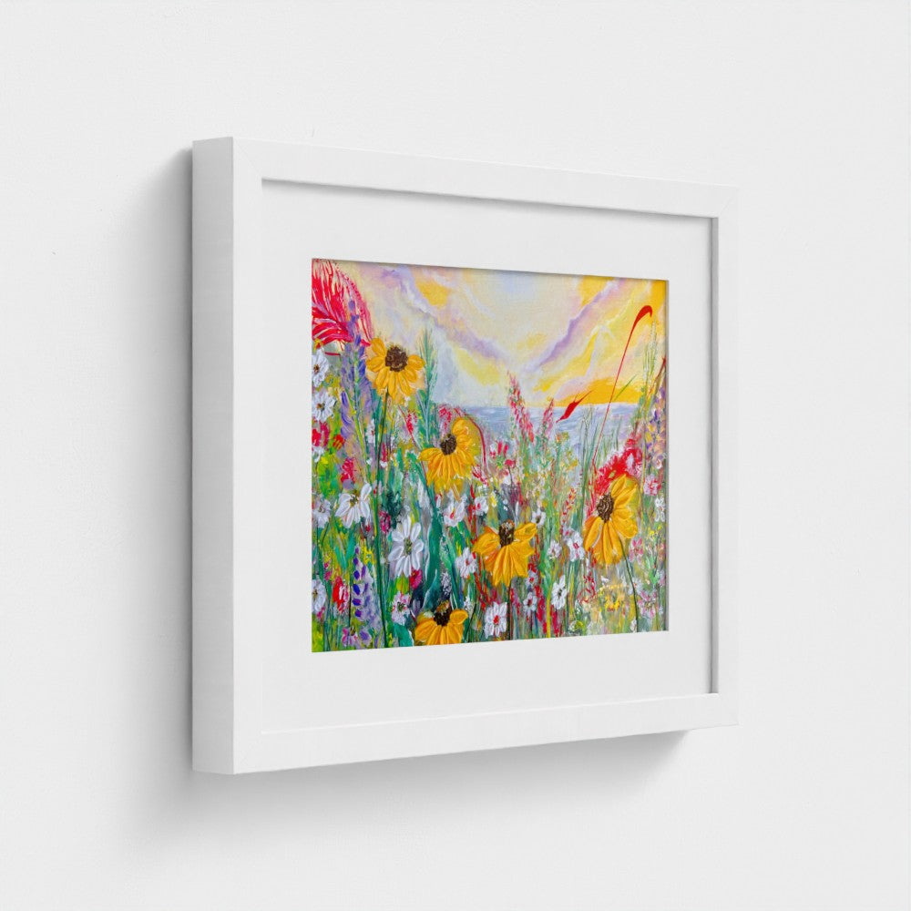Framed mounted print of colorful daisy meadow with white frame