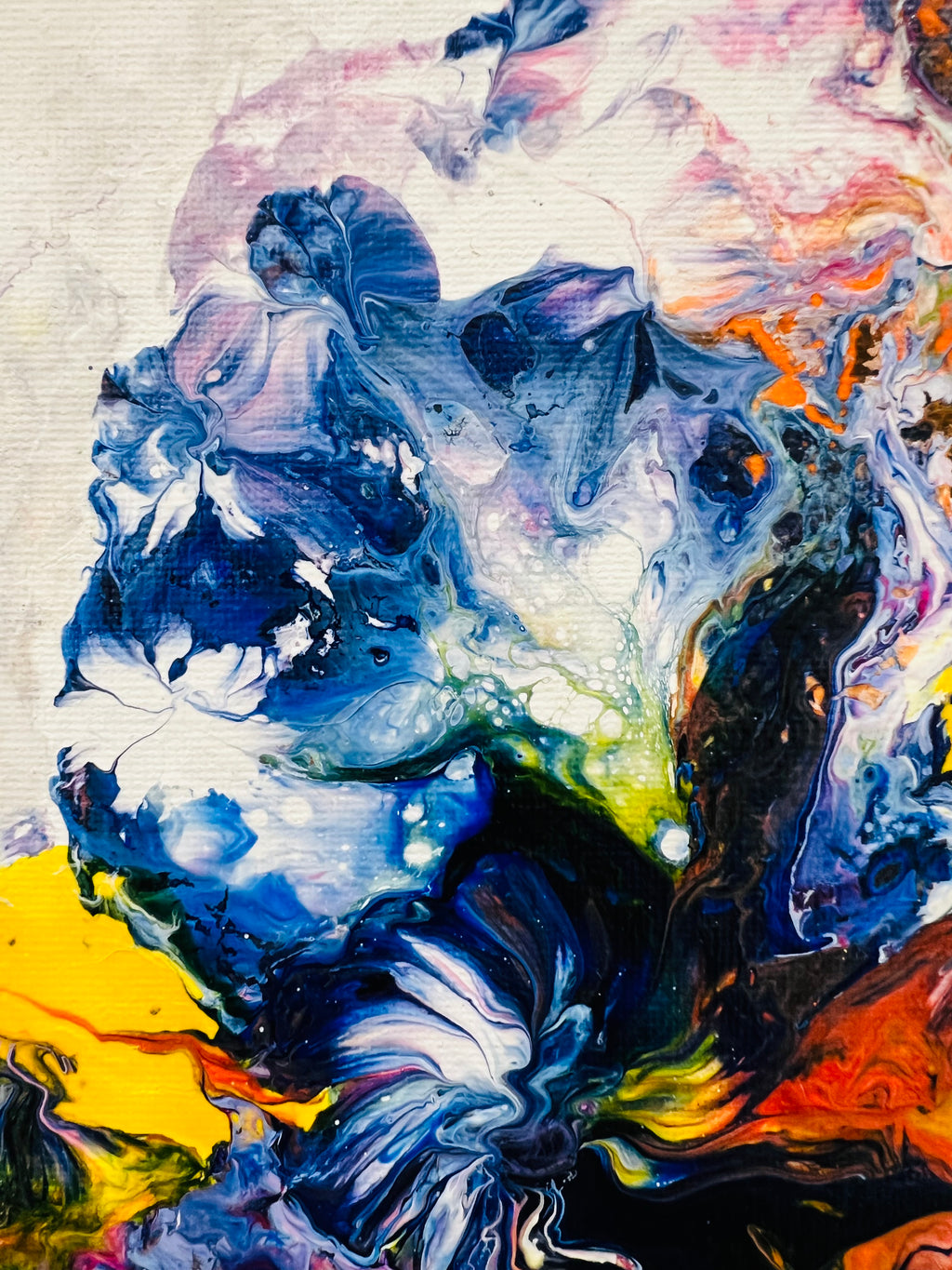 Abstract canvas detail with blue flower-like forms and orange-yellow highlights