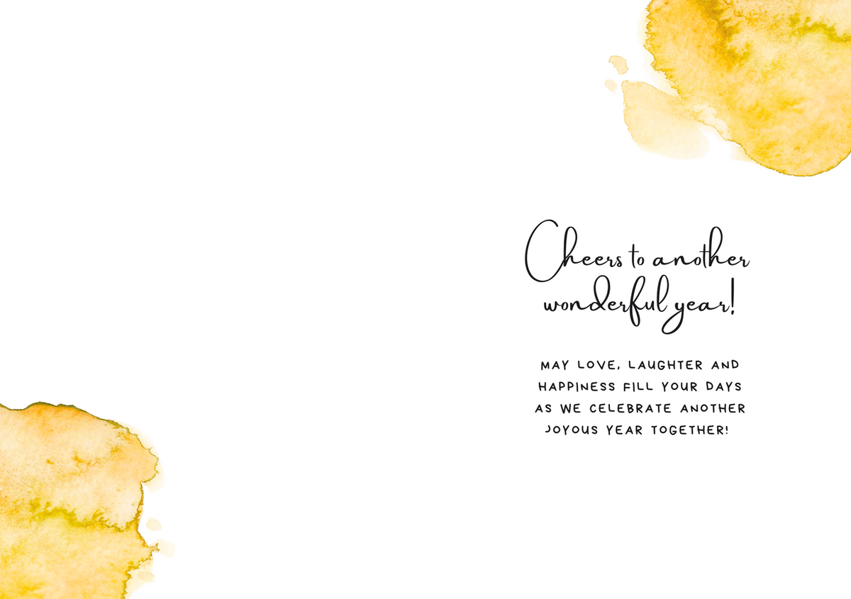Anniversary greeting card with watercolor yellow splashes and cursive “Cheers to another wonderful year!”