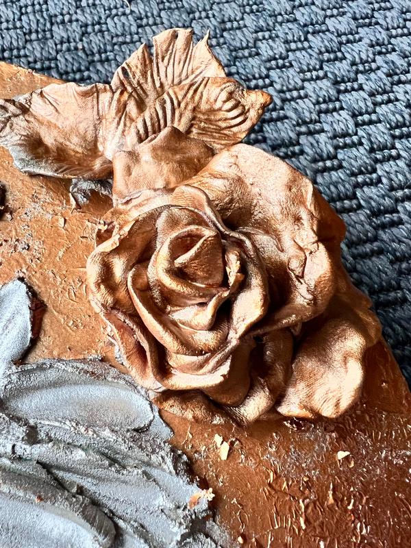 ETERNAL BLISS bronze rose relief with gray leaves on terracotta base, close-up