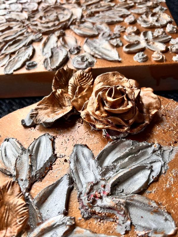 ETERNAL BLISS bronze rose and gray leaf relief on terracotta, angled view
