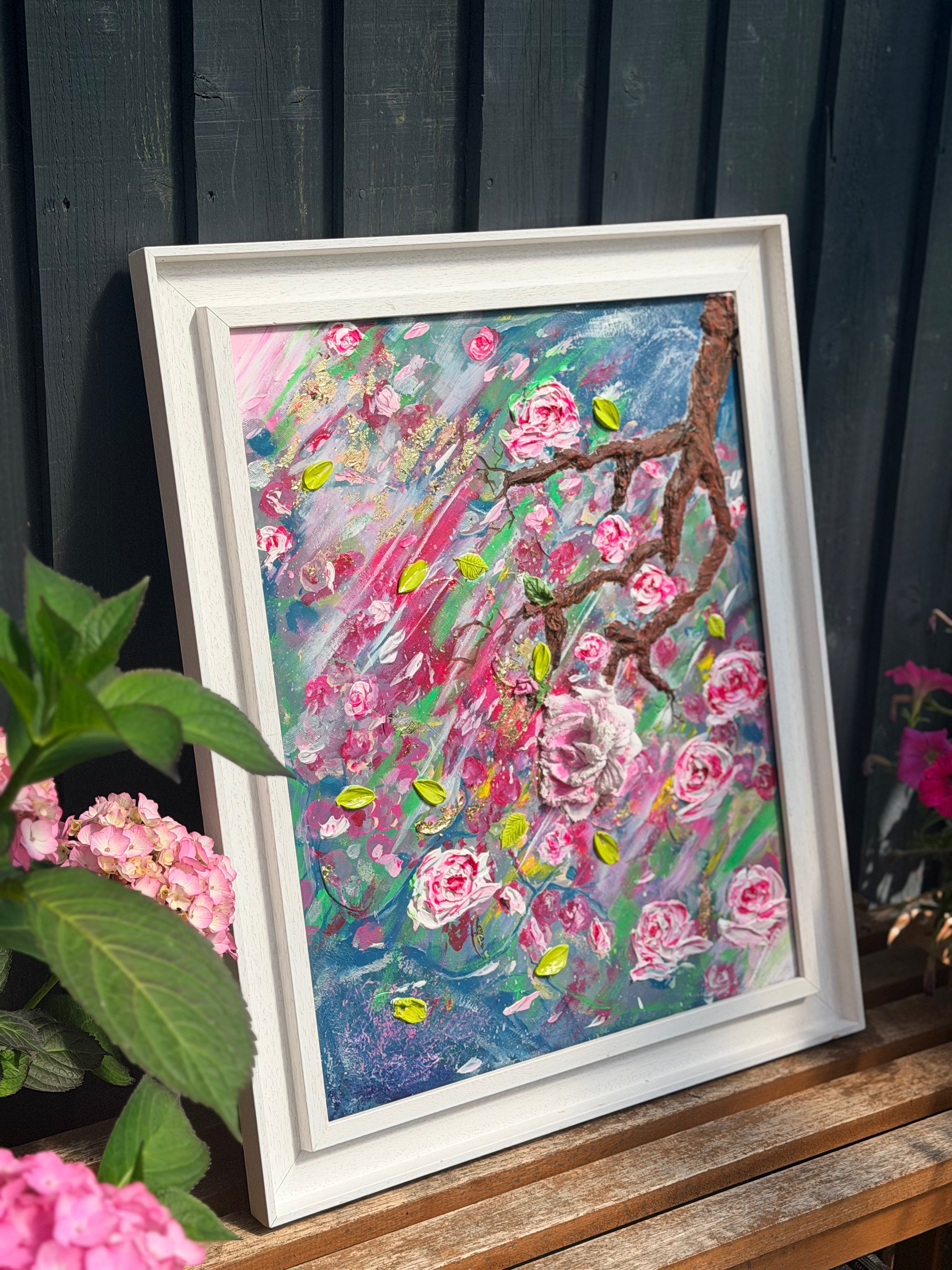 Framed textured floral artwork with pink roses, leafy accents, and multicolor impasto