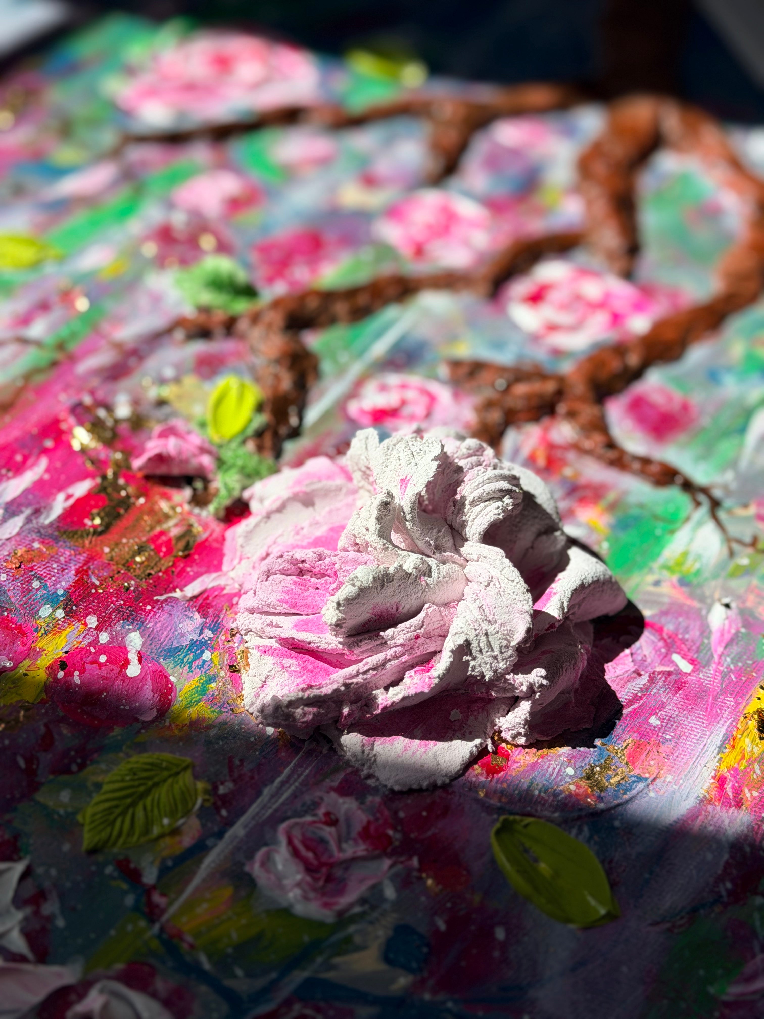 Textured floral painting close-up with raised white-and-pink rose relief and green leaves