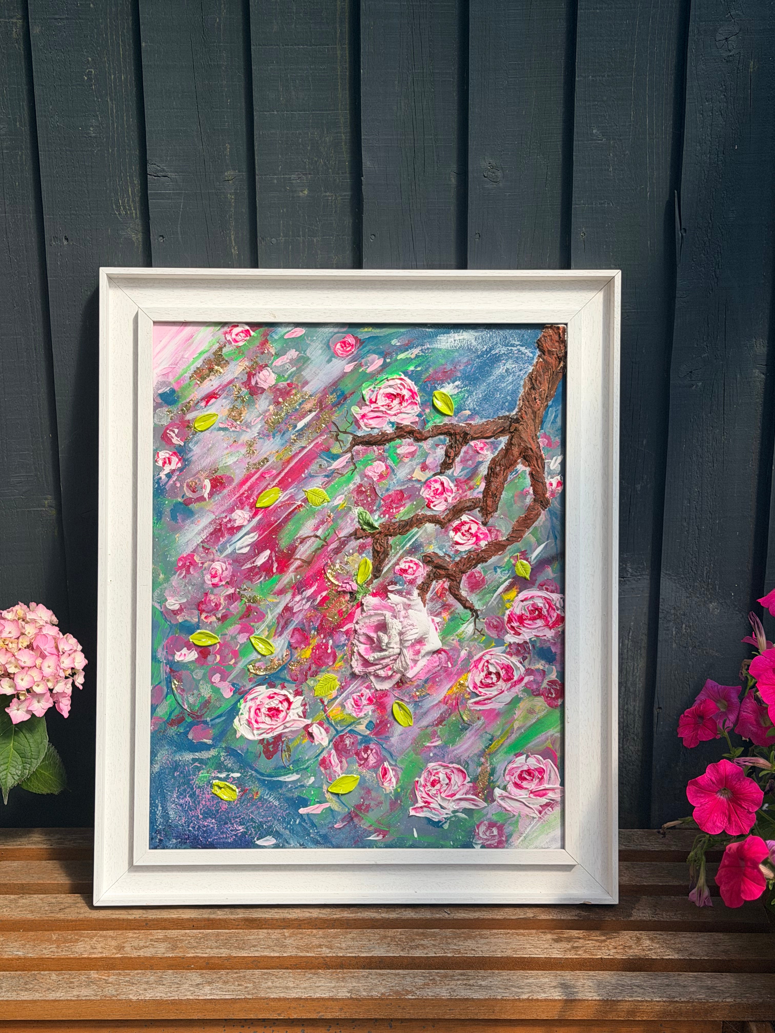 Framed textured floral painting featuring many pink roses on blue, pink, and green paint