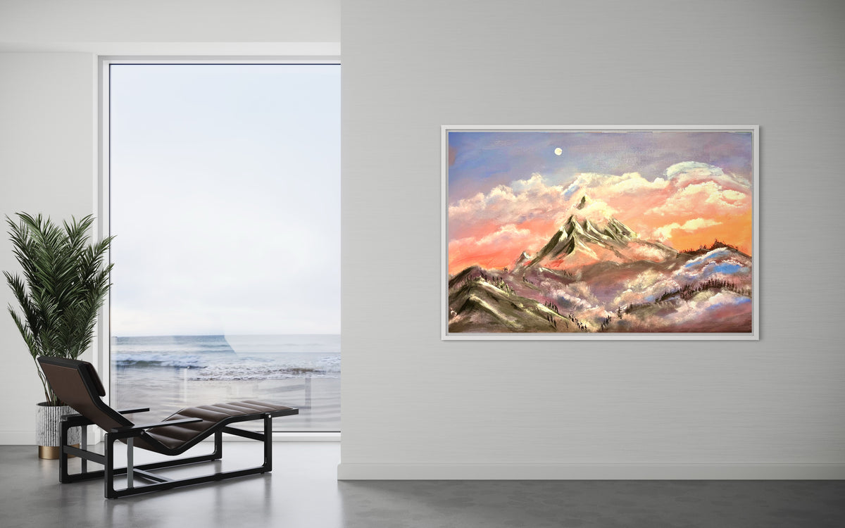 Framed mountain sunrise artwork on a wall with golden light, clouds, and snowcapped peaks