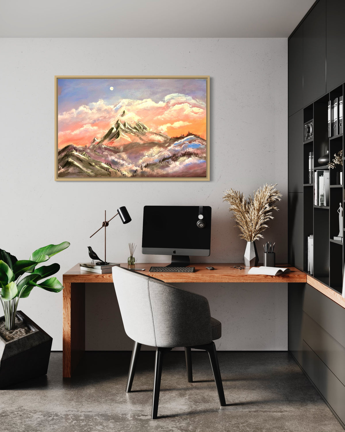 Framed mountain sunrise artwork on a wall with gold frame, clouds, and snowcapped peaks