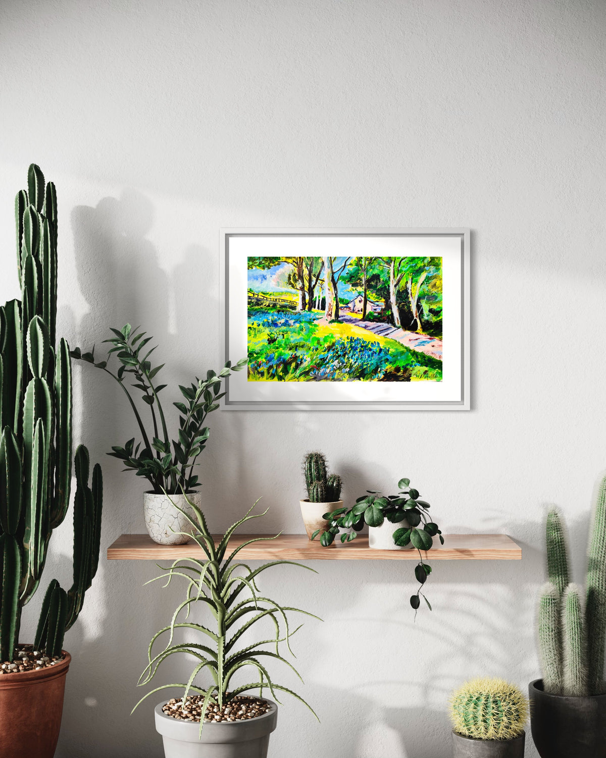 Framed watercolor landscape painting featuring bluebells, trees, and a walkway in woods