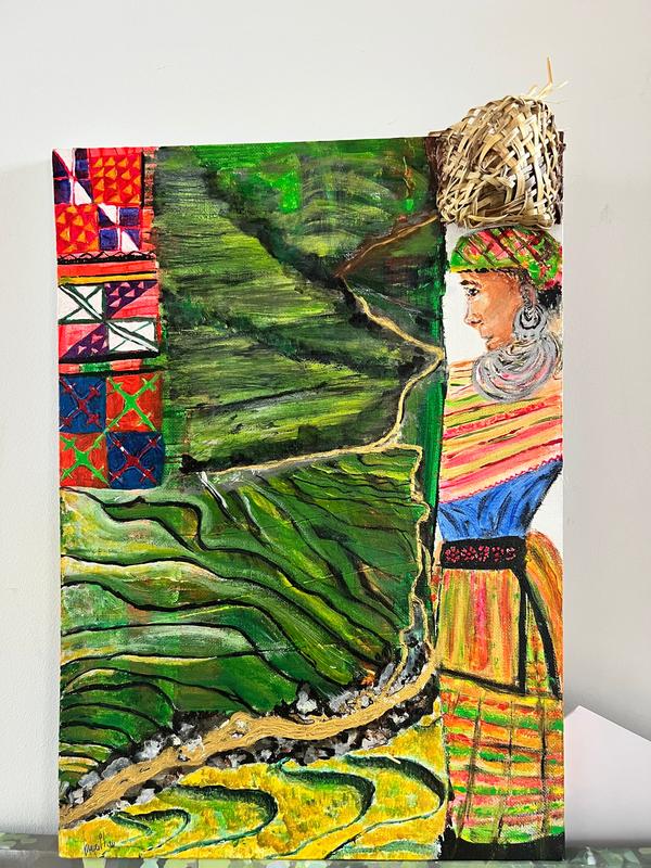 Framed wall art featuring green rice terraces and a colorful robed woman portrait.
