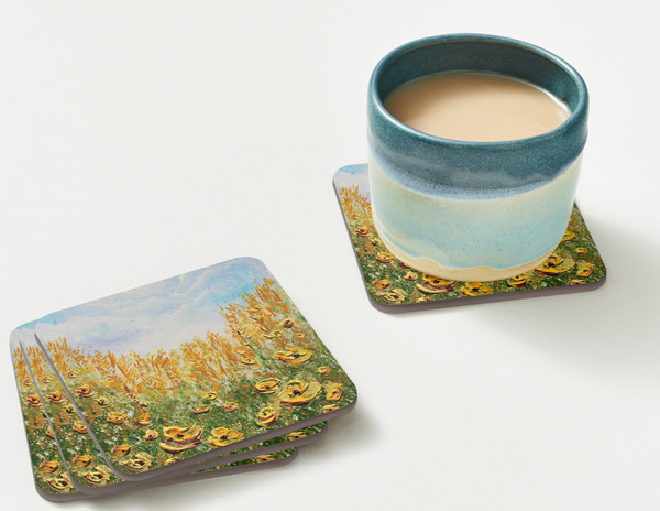 set of 4  9.5cm art coaster featuring a painted golden poppy field with amber grasses and a soft blue sky
