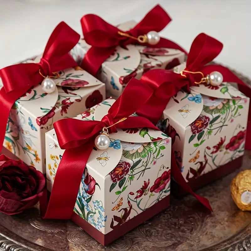 Hand-painted ceramic Christmas bauble gifts with red bows and pearl accents