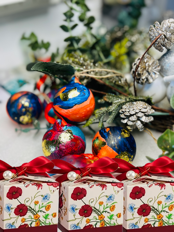 Set of hand-painted ceramic Christmas baubles with blue, orange, red, and gold leaf
