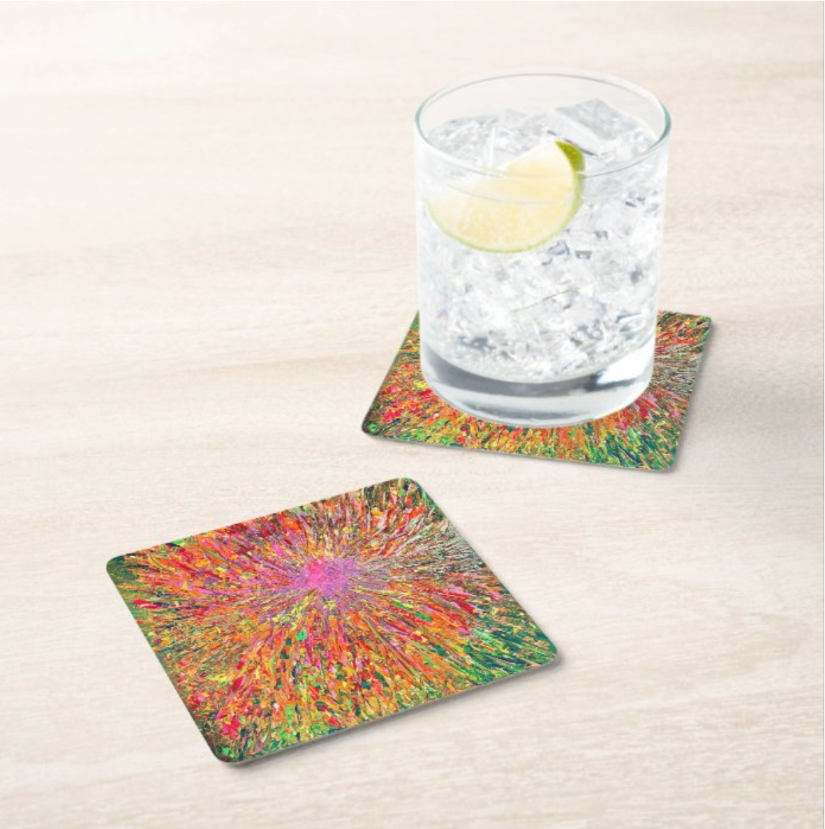 Square hardboard coaster with a vibrant green and red abstract sunburst design and a glossy heat-resistant finish.