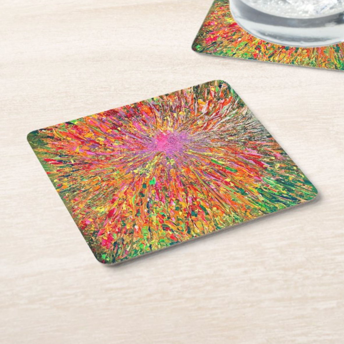 Colorful abstract coaster with green, red and purple radial burst paint