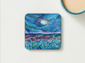 Square hardboard coaster featuring colorful galaxy sky and landscape print