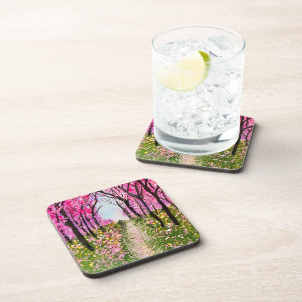 Square 9.5cm hardboard coaster with a glossy pink cherry tree walkway painting, shown with a glass of water on a table.